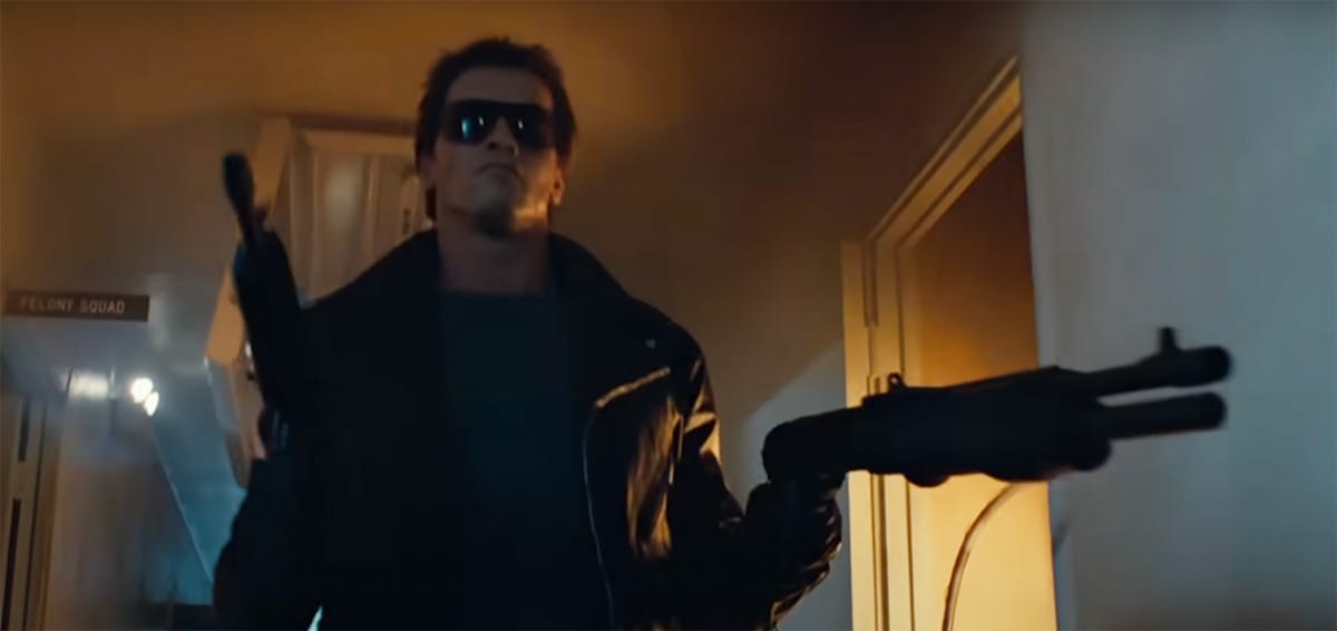 "The Terminator, wearing sunglasses and wielding a shotgun, advances through a building corridor with deadly intent."