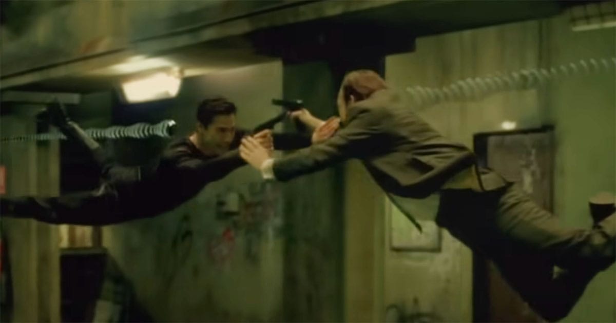 Neo and Agent Smith collide mid-air during a dramatic fight scene in "The Matrix."