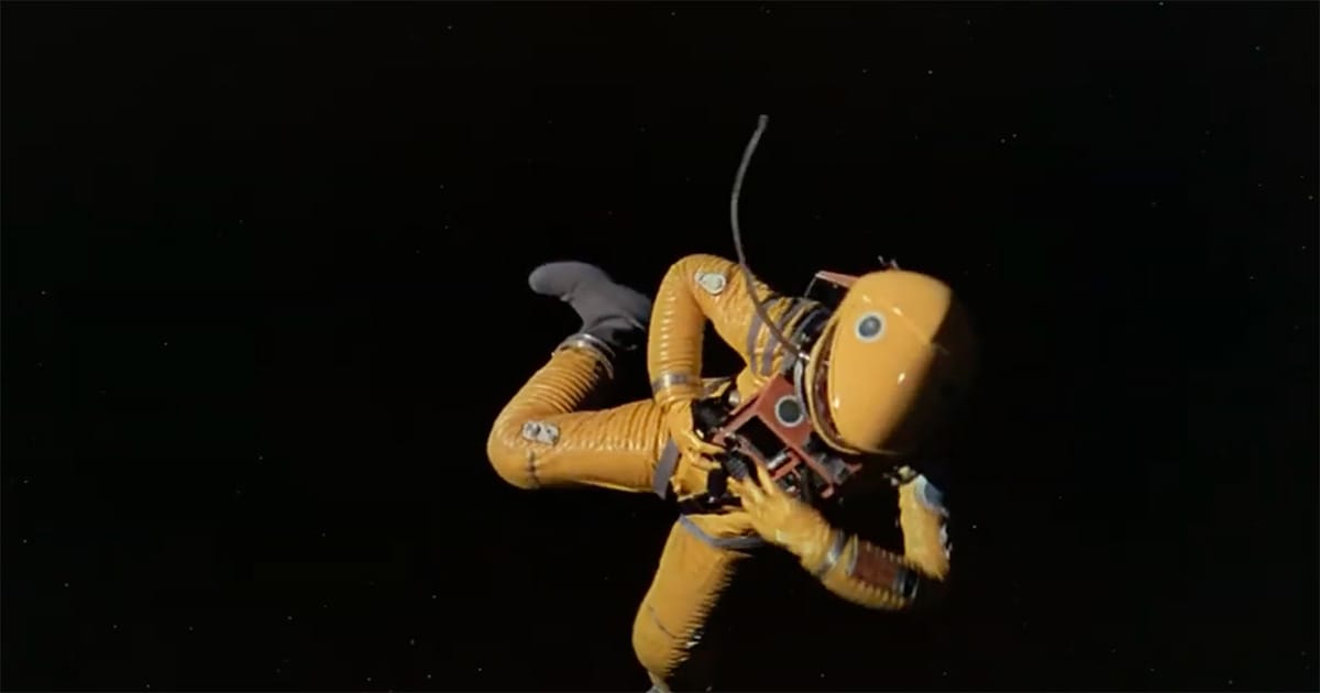 Astronaut Frank Poole in a yellow suit drifting in space after being attacked by HAL in "2001: A Space Odyssey"