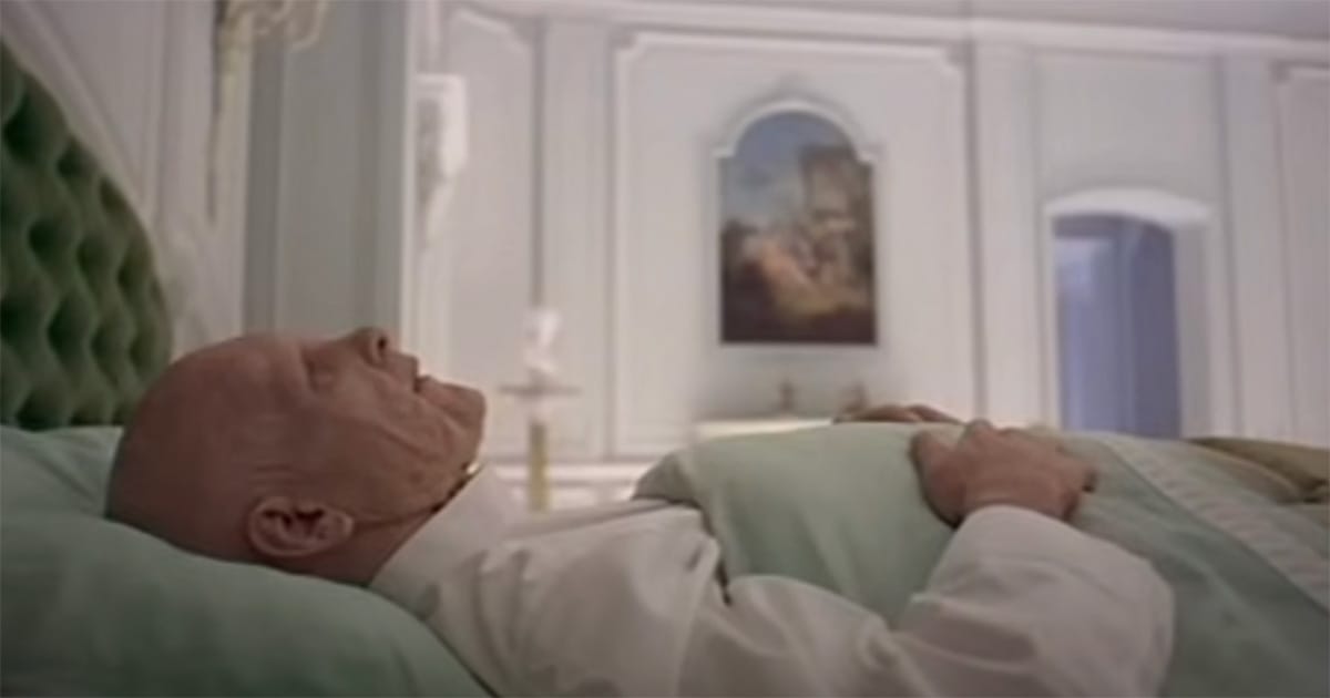 Elderly Dave Bowman lying in bed in the neoclassical chamber with the monolith in "2001: A Space Odyssey"