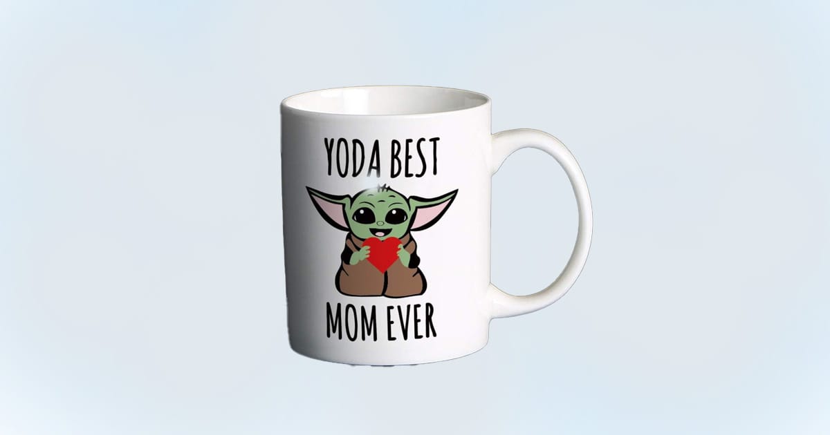White coffee mug with Baby Yoda holding a red heart and the phrase “Yoda Best Mom Ever” printed above and below the image.