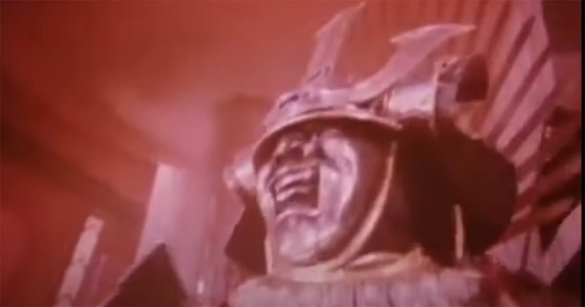 A surreal, red-tinted dream figure in heavy samurai armor with a distorted, screaming face, representing the nightmarish elements of Terry Gilliam’s "Brazil" (1985).
