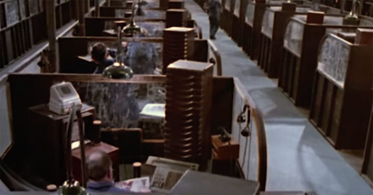 Rows of cubicles in the Ministry of Truth where Party workers alter historical records in the 1984 film adaptation of Nineteen Eighty-Four.