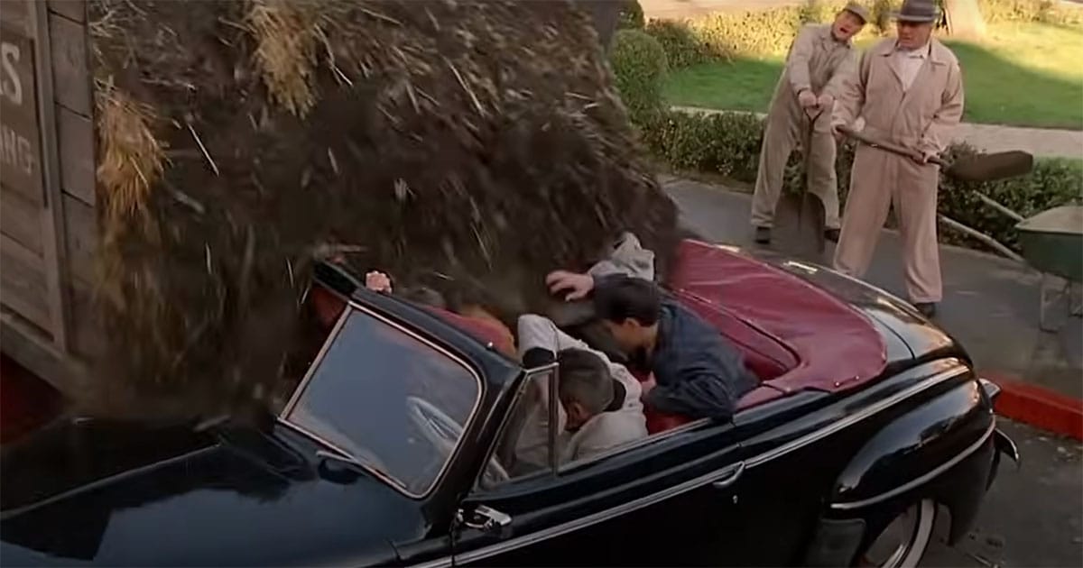 Biff Tannen and his gang getting buried in manure in a convertible during a chase in "Back to the Future," a classic comedic moment symbolizing well-earned comeuppance.