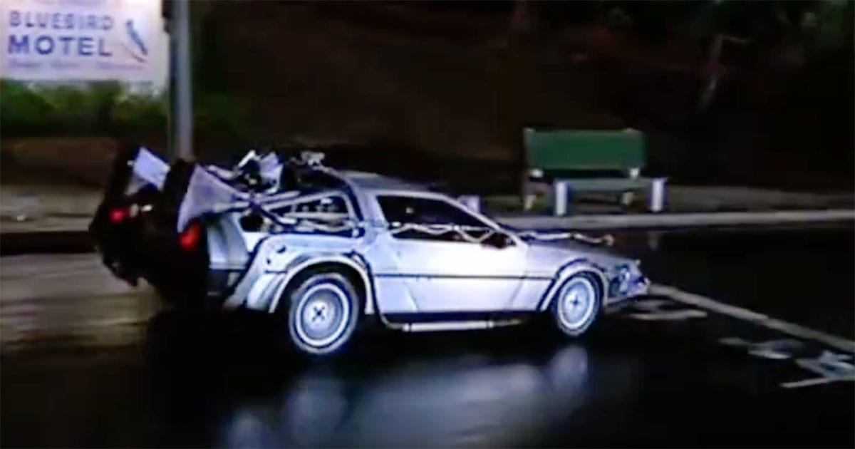 The DeLorean time machine speeding through a rainy street in "Back to the Future," moments before jumping back to 1955.
