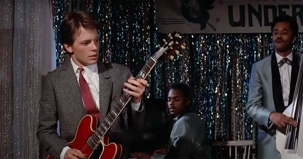Marty McFly playing guitar at the Enchantment Under the Sea dance in "Back to the Future," symbolizing how a teenager’s actions in the past shape his future.
