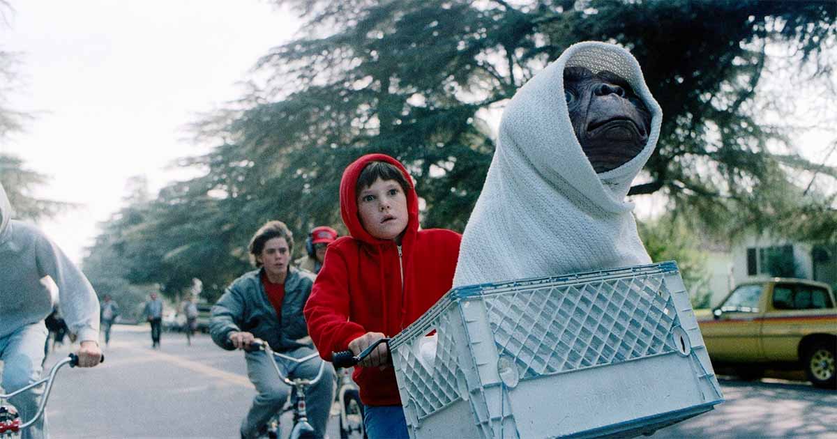 A screen capture from the film showing E.T. in a blanket on the front of the bike.