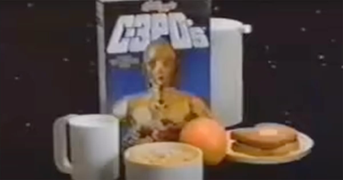 C-3PO’s cereal box with a breakfast setting including orange juice, toast, and a bowl of cereal.