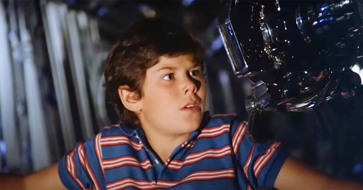 A surprised David Freeman looks at Max the robot inside the spaceship in Flight of the Navigator