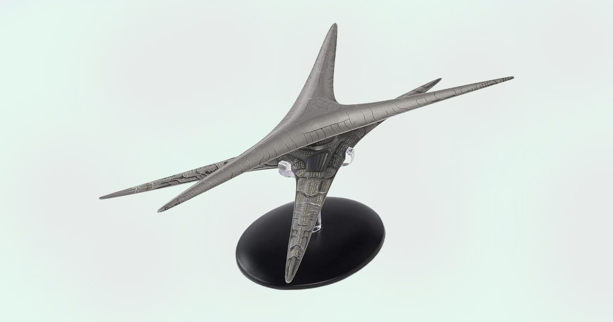 Battlestar Galactica Basestar replica model with detailed bio-mechanical design on display stand.