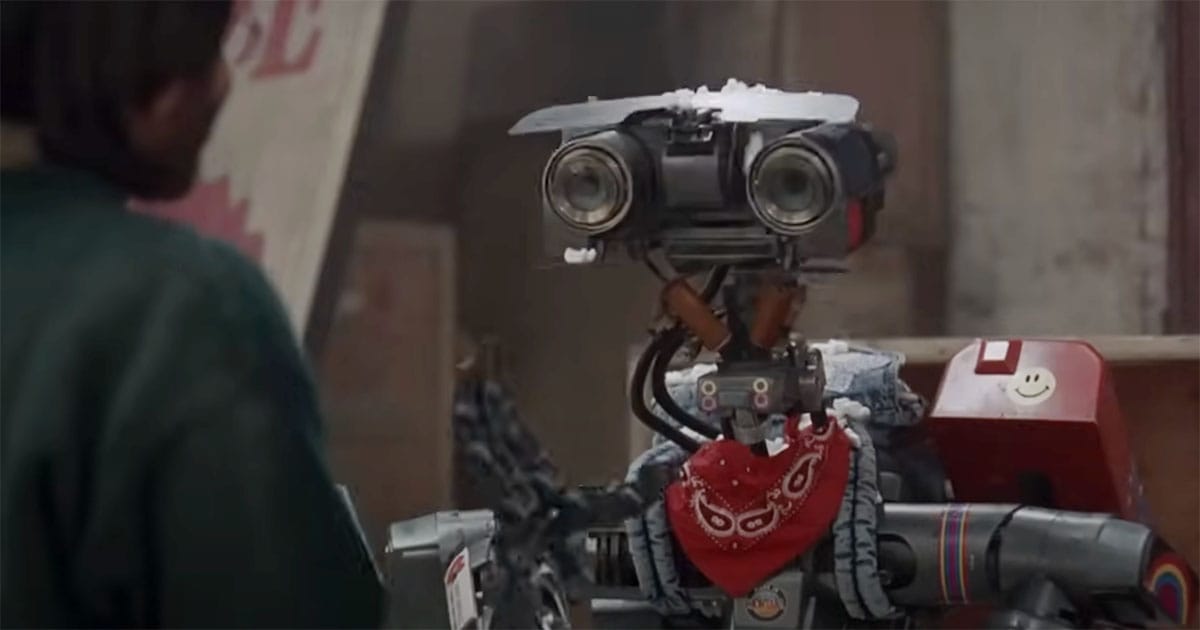 Johnny 5 from "Short Circuit" wearing a bandana and stickers, showing his growing individuality.