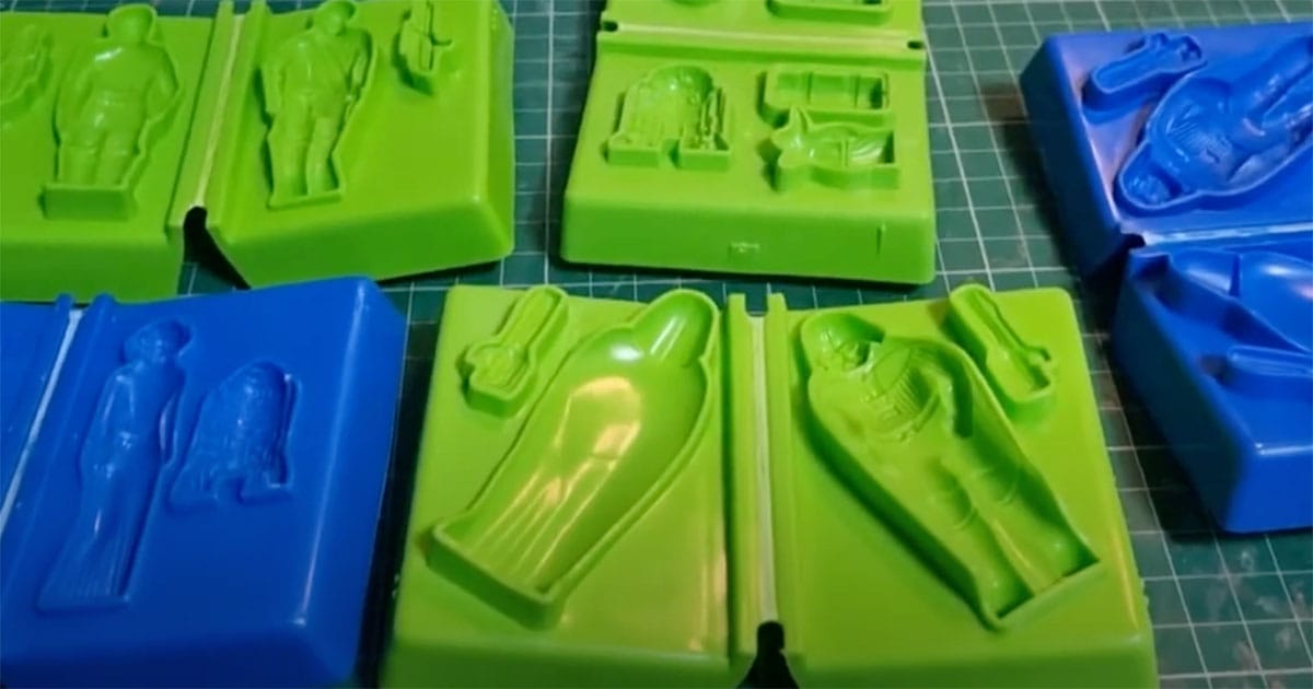 Vintage Star Wars Play-Doh plastic molds in green and blue, shaped like characters and ships including Darth Vader and R2-D2.