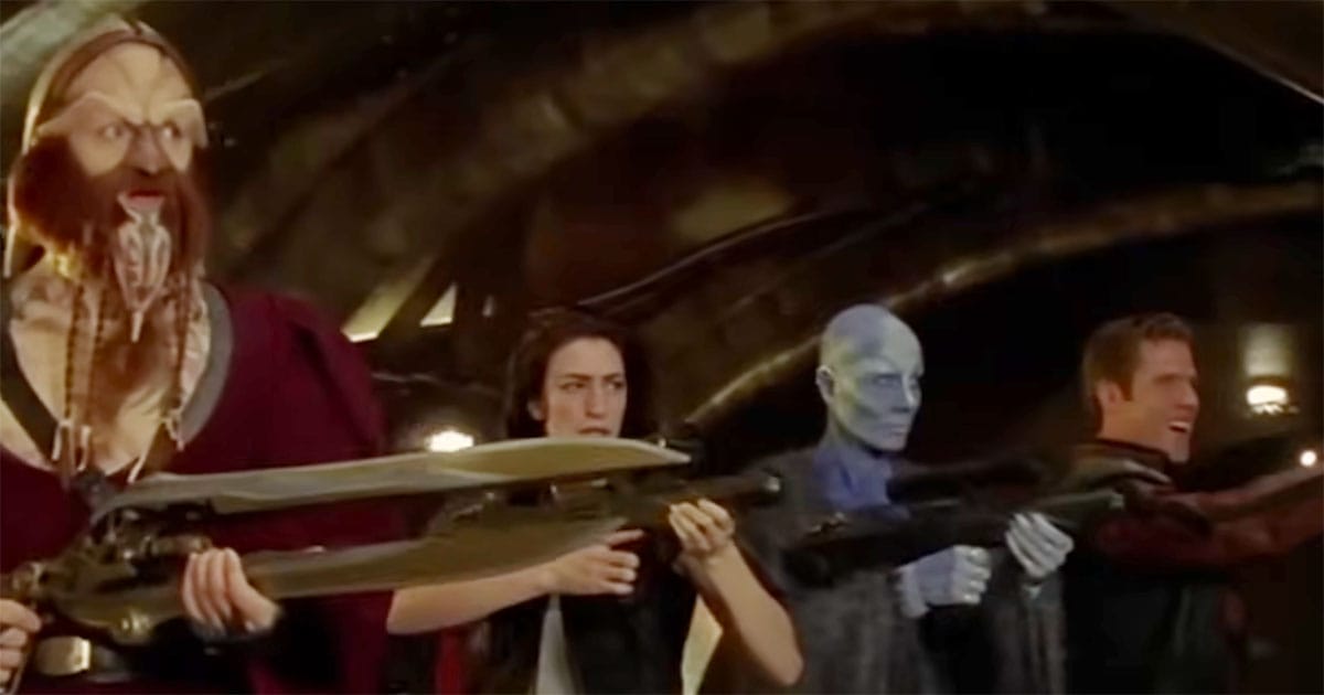 Scene from "Farscape" showing D’Argo, Aeryn, Zhaan, and Crichton standing together with weapons ready aboard Moya.