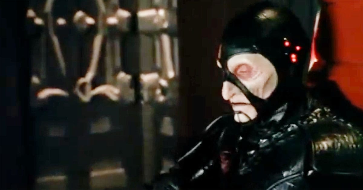 Close-up from "Farscape" showing Scorpius seated in shadow aboard a Peacekeeper vessel, symbolizing unchecked authority.