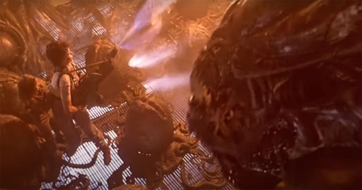 Ripley and Newt walking through the alien hive with eggs and the Queen in view during Aliens 1986 finale