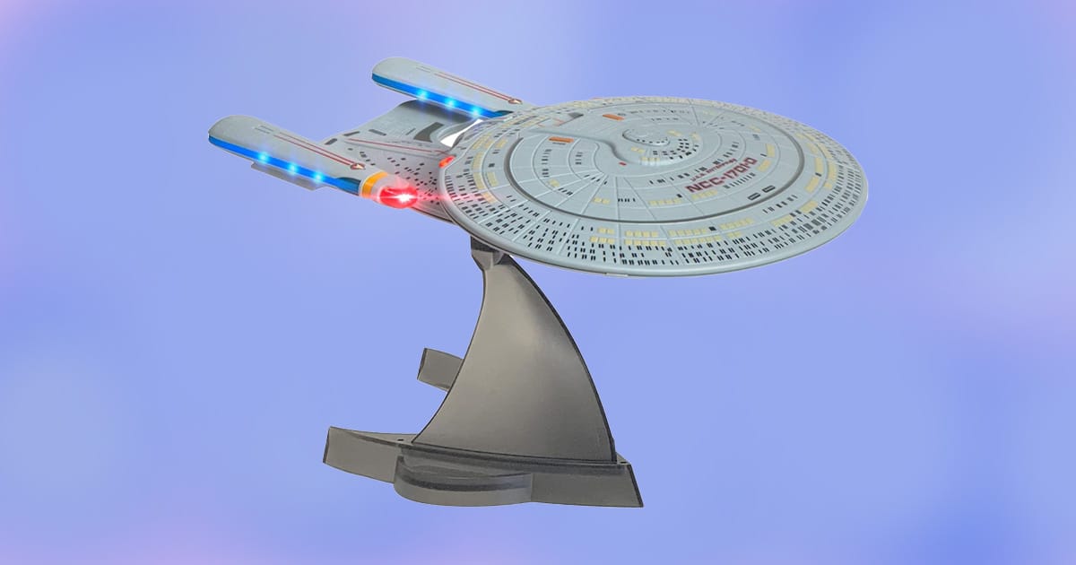 Star Trek USS Enterprise 1701-D Bluetooth speaker replica with LED lights on display stand.