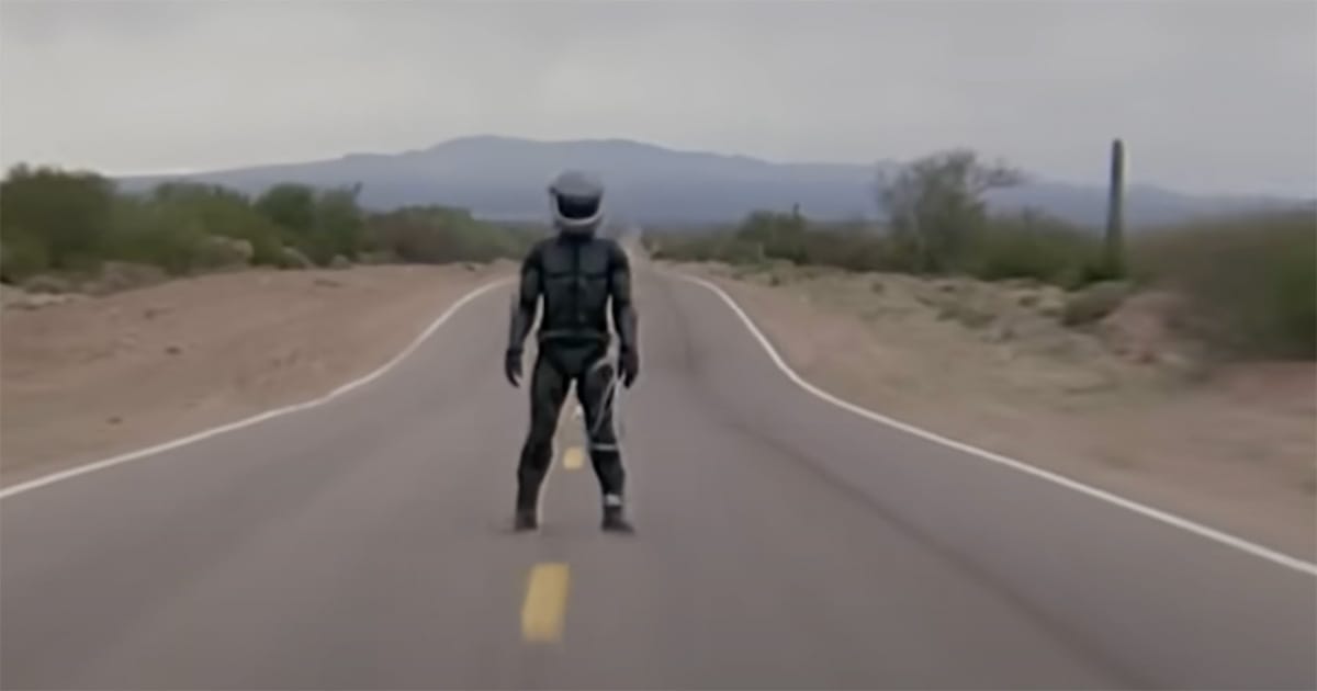 The Wraith character stands alone in the middle of a desert highway in "The Wraith," symbolizing isolation, identity, and the road to redemption.