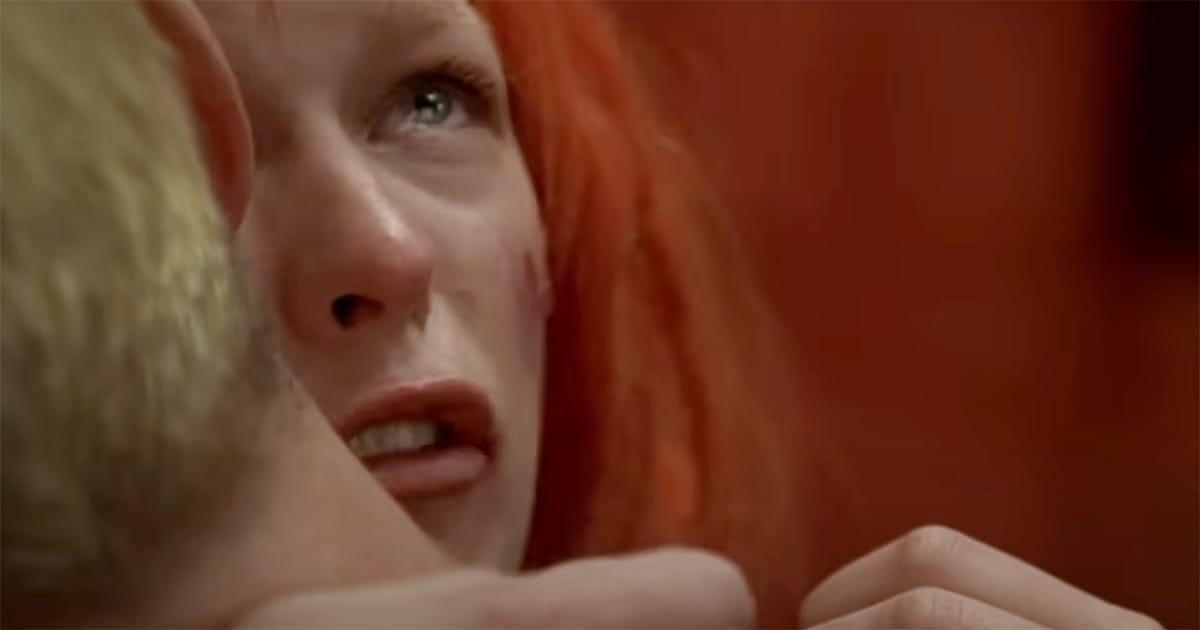 Close-up of Leeloo crying in Korben’s arms after absorbing images of war and destruction.