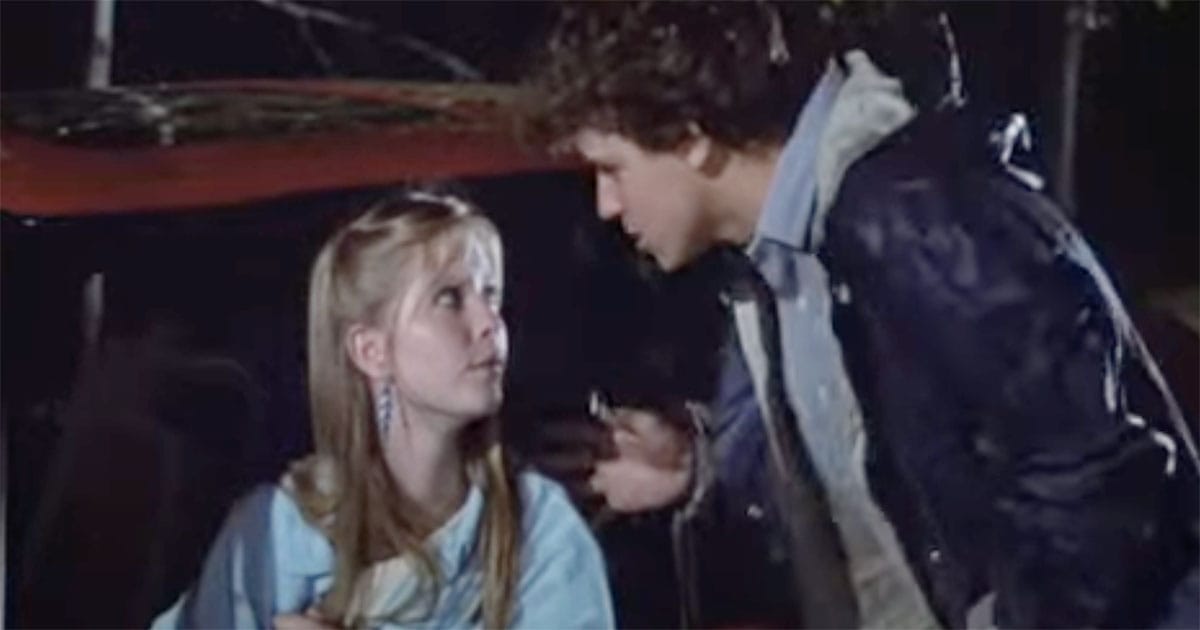 Paul Stephens speaks with Jenny beside a car at night in “The Manhattan Project” (1986), reflecting on the emotional and ethical consequences of his actions.