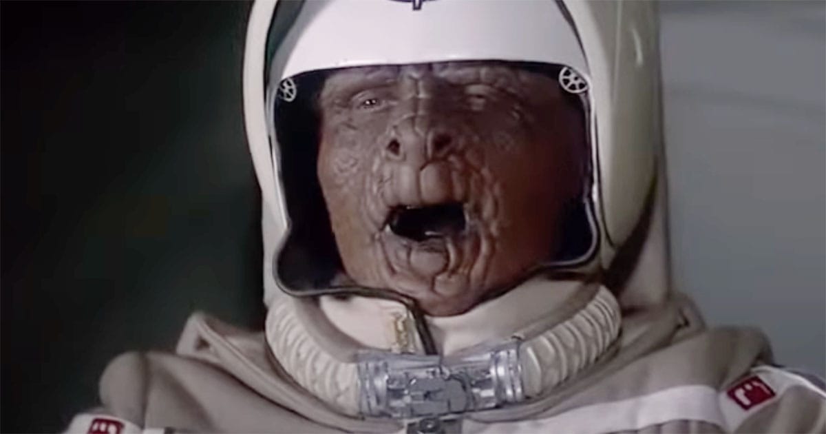 Grig, the alien co-pilot, sitting beside Alex in the Gunstar cockpit wearing a pilot uniform and helmet.
