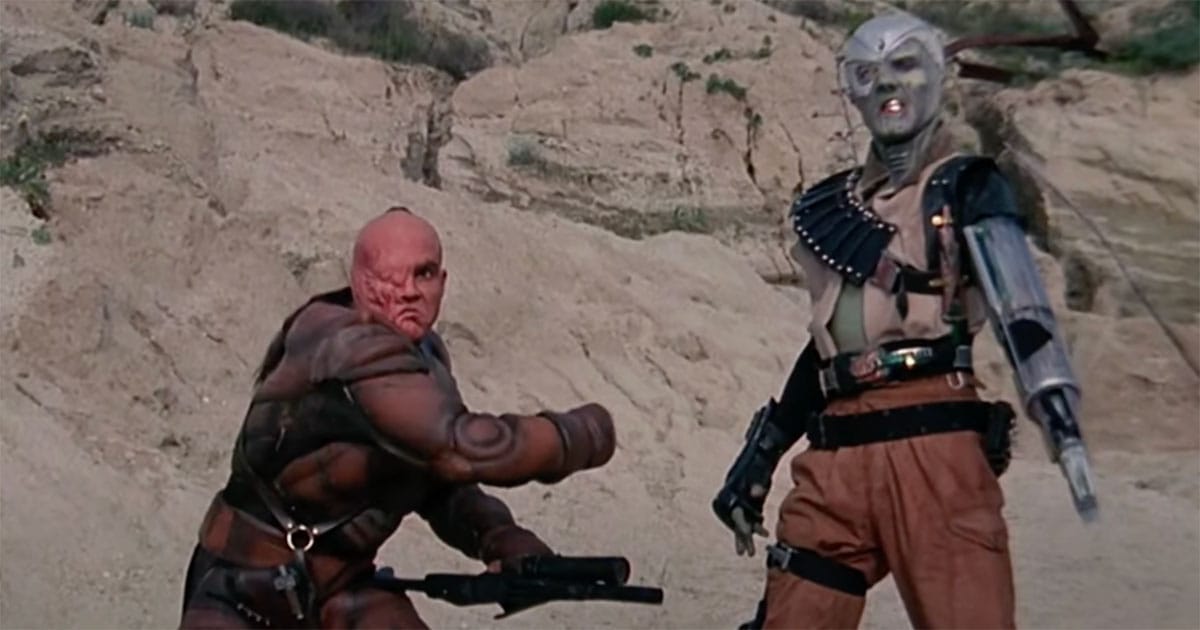 Two villain characters from "Metalstorm The Destruction of Jared-Syn" posed in desert rock formations.