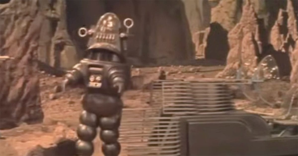 Robby the Robot exploring the rocky terrain of Altair IV in the 1956 science fiction classic "Forbidden Planet," symbolizing the blend of technology and alien wonder.