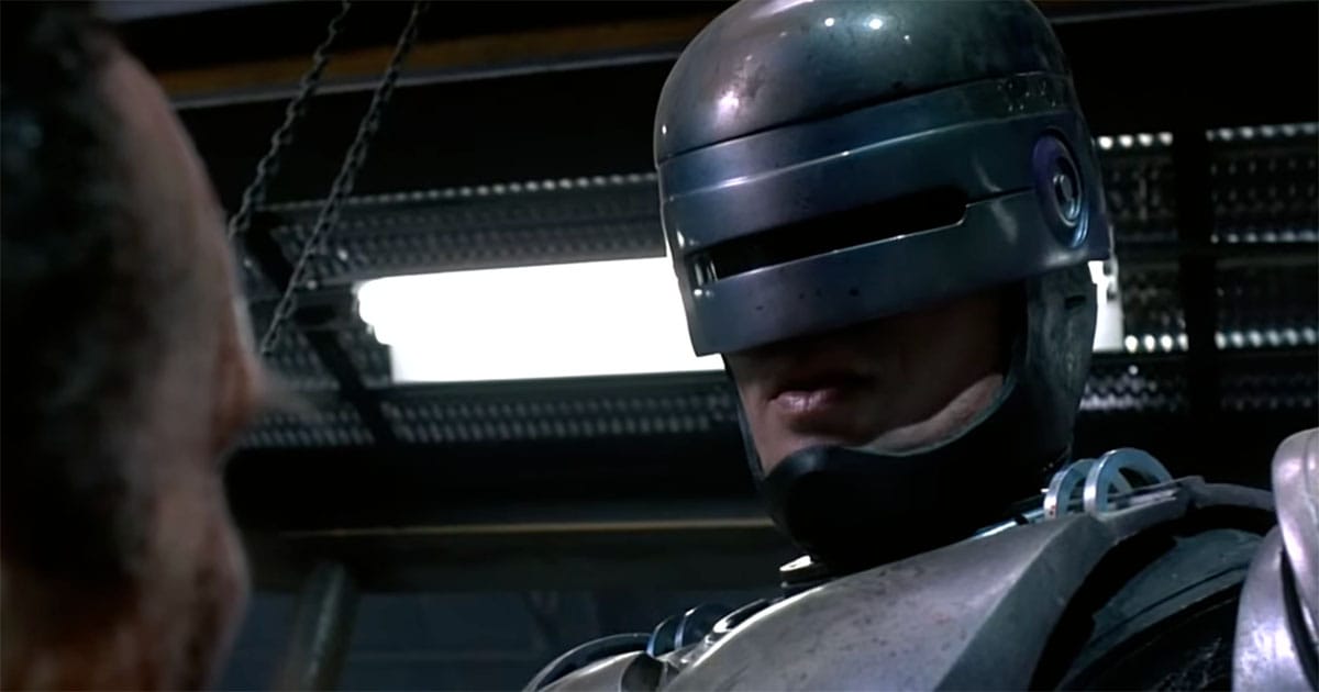 Close-up of RoboCop confronting an adversary in the 1987 film "RoboCop," reflecting his struggle between human judgment and corporate programming.