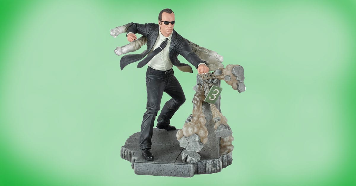 Diamond Select Agent Smith PVC diorama from The Matrix, 10-inch statue of Agent Smith in black suit punching through rubble with motion effect arms.
