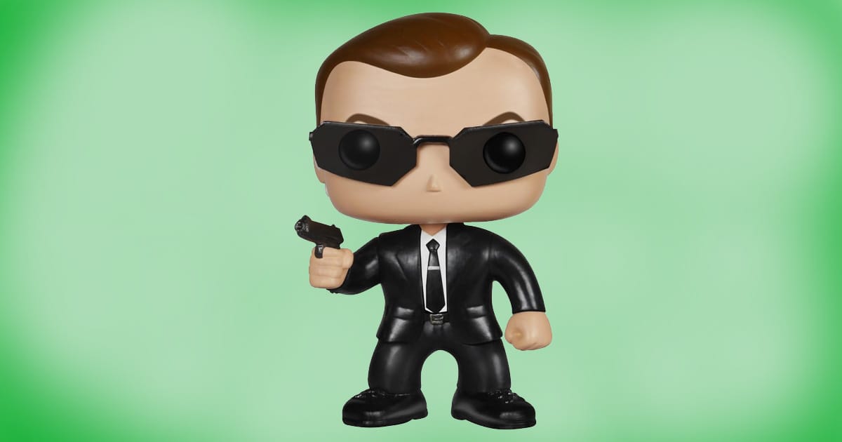 Funko POP vinyl figure of Agent Smith from The Matrix wearing black suit and sunglasses, holding pistol collectible toy.