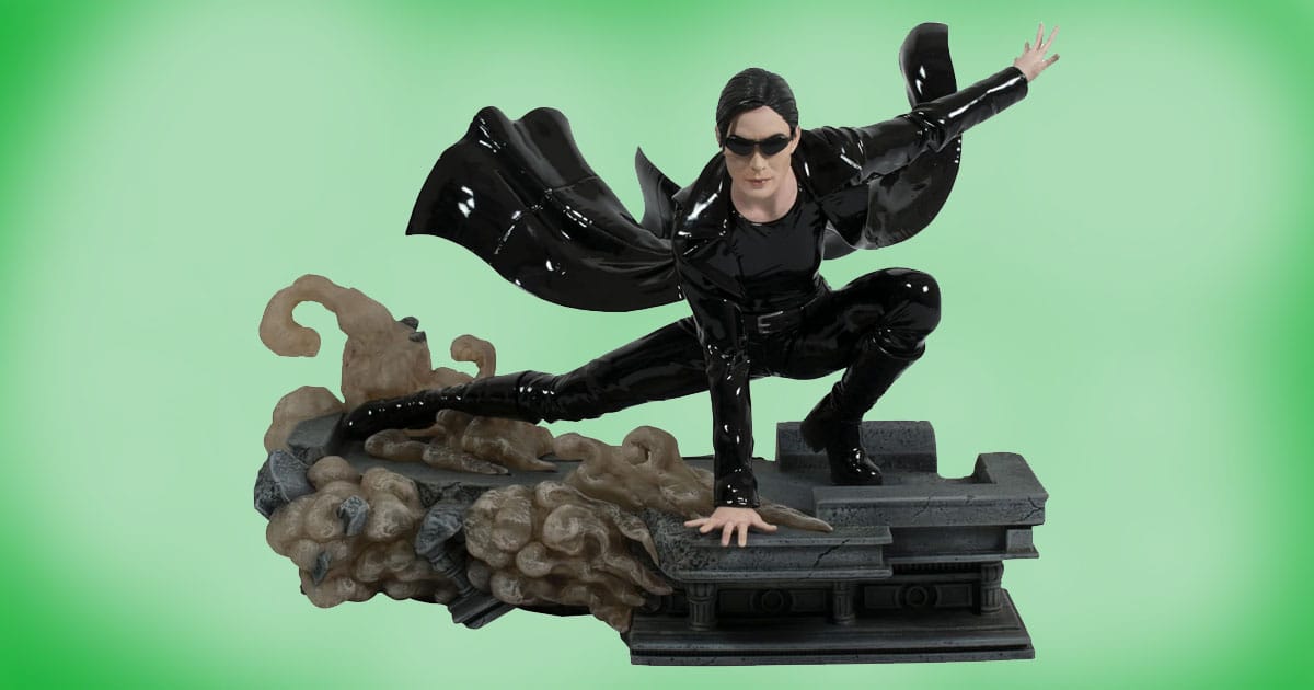 The Matrix Gallery Trinity Deluxe PVC Statue collectible diorama, Trinity in black suit crouching mid-action on a stone base with smoke effect.