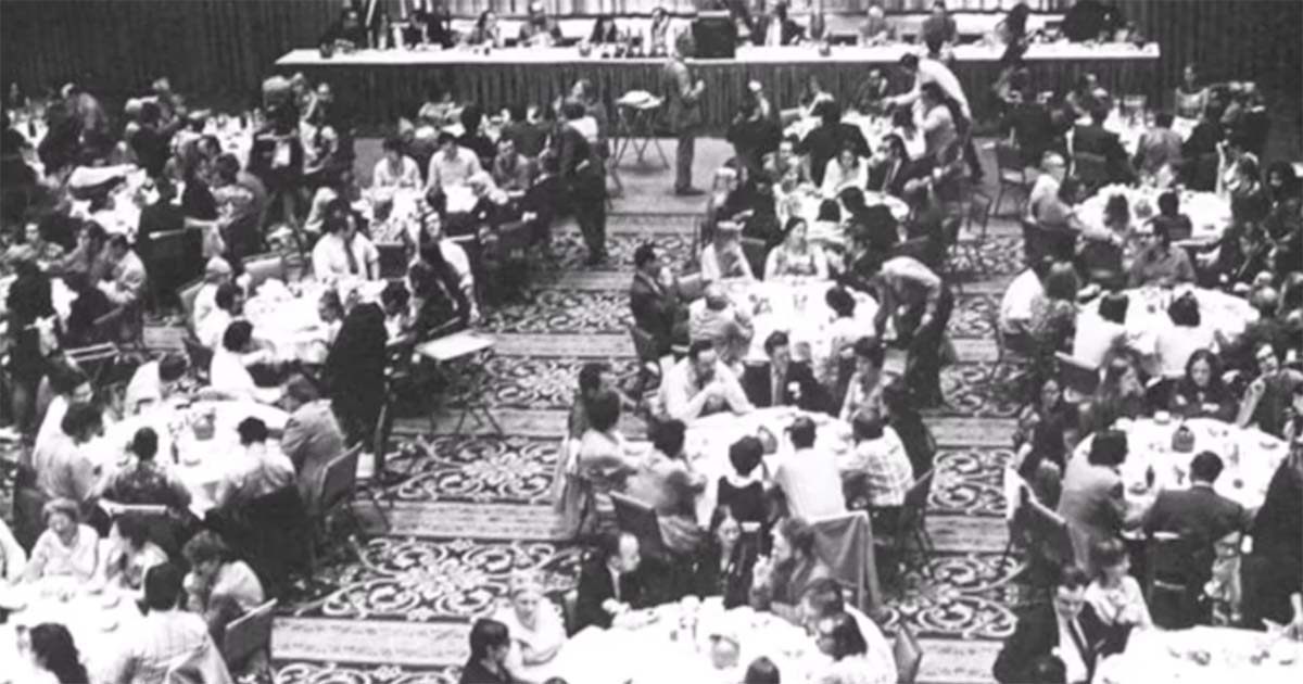Man holding a Hugo Award trophy on stage at the 29th World Science Fiction Convention Noreascon I in 1971.