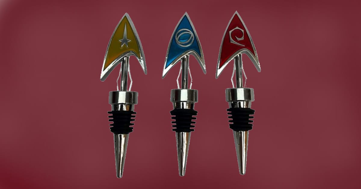 Set of three Star Trek Delta bottle stoppers featuring gold command, blue science, and red engineering insignia.