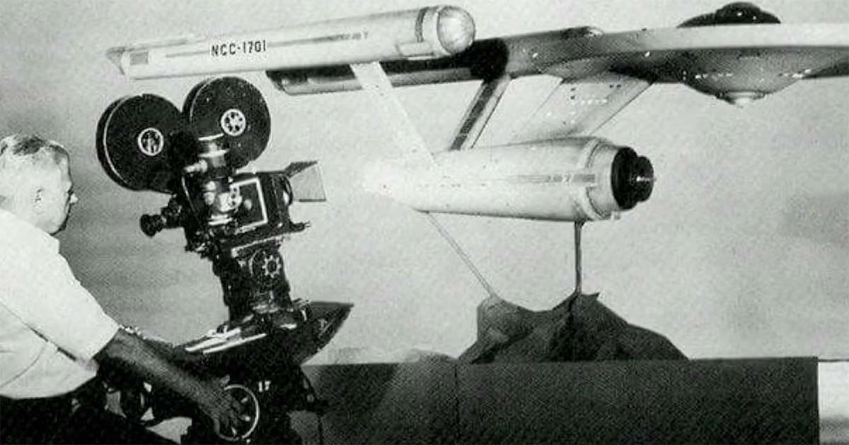 Black-and-white photo of USS Enterprise model on filming rig for "Star Trek"