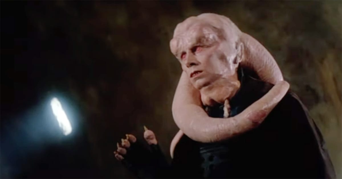 Star Wars scene showing Bib Fortuna with pale skin and long head-tails, standing in Jabba’s palace as one of the most memorable background characters of the original trilogy.
