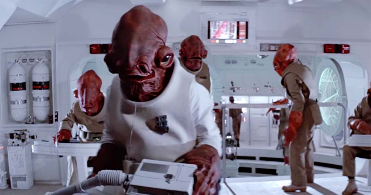 Star Wars scene of Admiral Ackbar on the bridge of a Rebel starship with fellow Mon Calamari officers, remembered as a standout background character of the original trilogy.