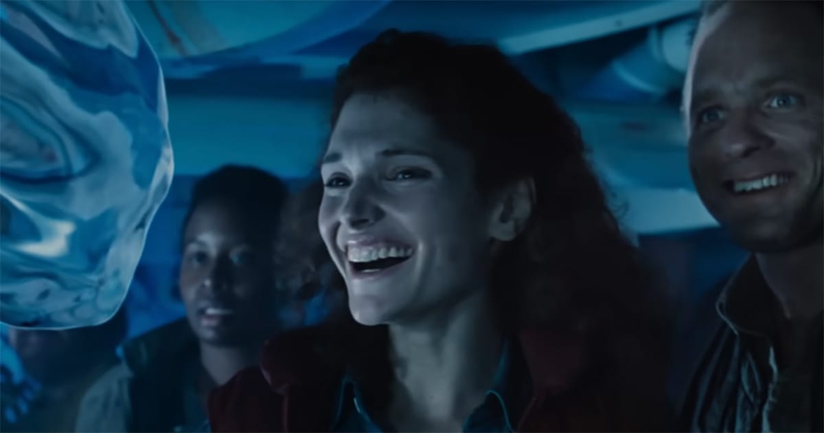 Characters Lindsey and Bud smiling at living water form in The Abyss symbolizing human connection and wonder.