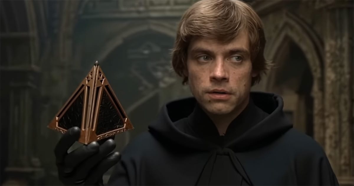 Luke Skywalker holding a triangular bronze holocron in a dim stone chamber.