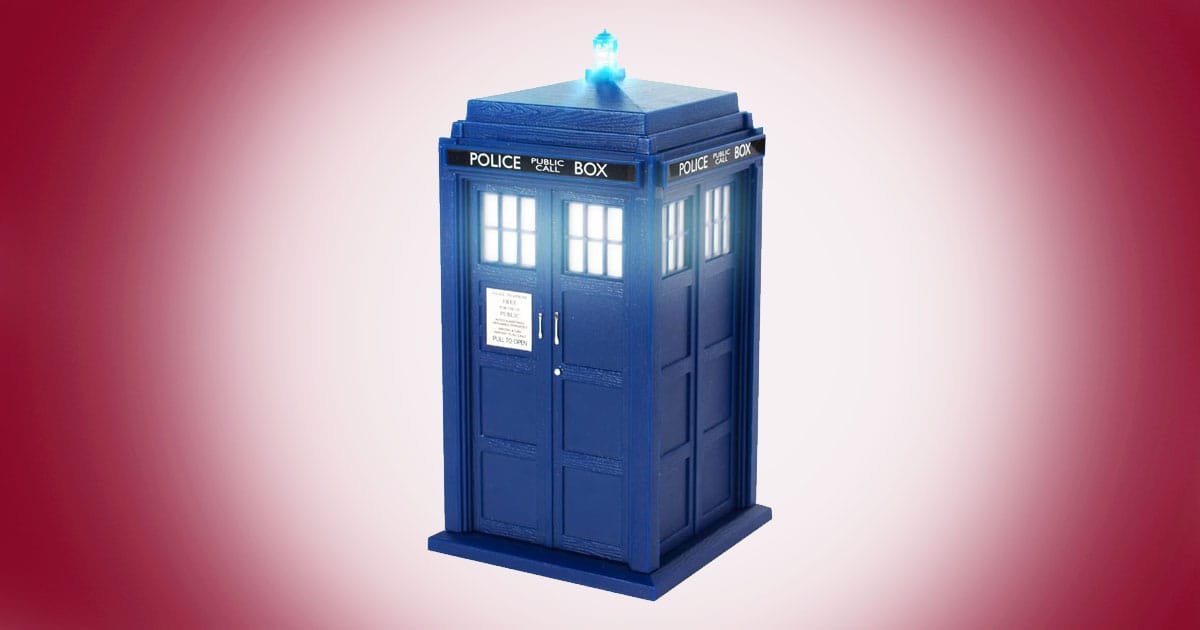 Doctor Who TARDIS Bluetooth speaker with glowing light on top and illuminated windows on red background.