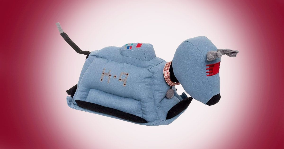 Doctor Who K-9 plush doorstop in blue fabric with red visor and plaid collar on red background.