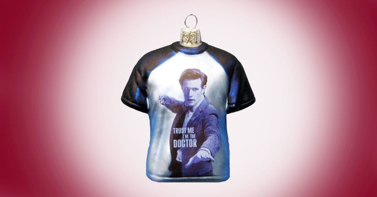 Doctor Who glass T-shirt Christmas ornament featuring the Eleventh Doctor with text that reads Trust Me I’m The Doctor on red background.