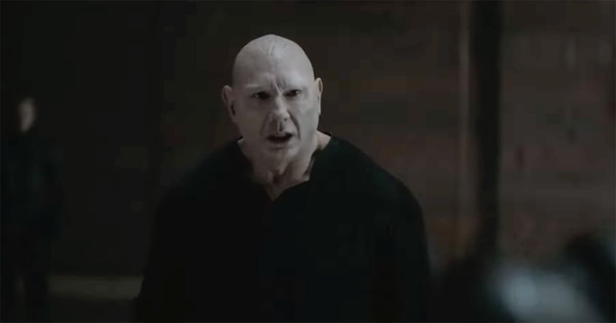 Dave Bautista as Glossu Rabban in Dune Part Two (2024), standing in a dim hall with a fierce expression