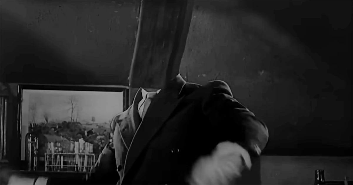 A man in a suit stands in a dark lab with part of his head invisible, illustrating scientific transformation.