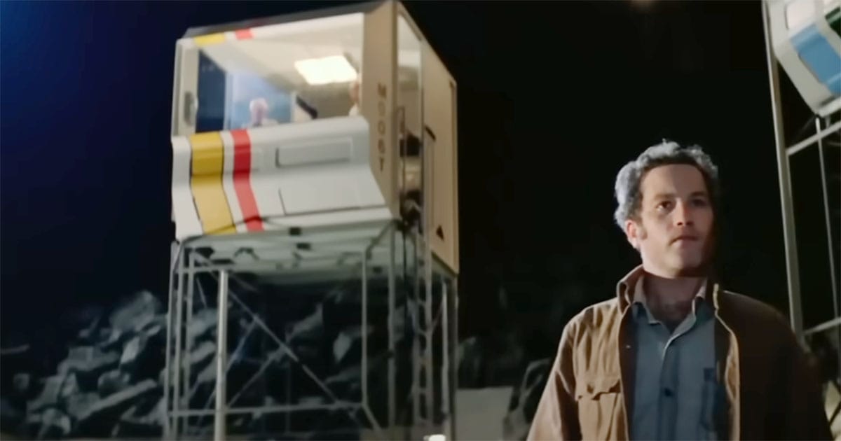 A man stands at the glowing landing site as the spacecraft descends in “Close Encounters of the Third Kind.”