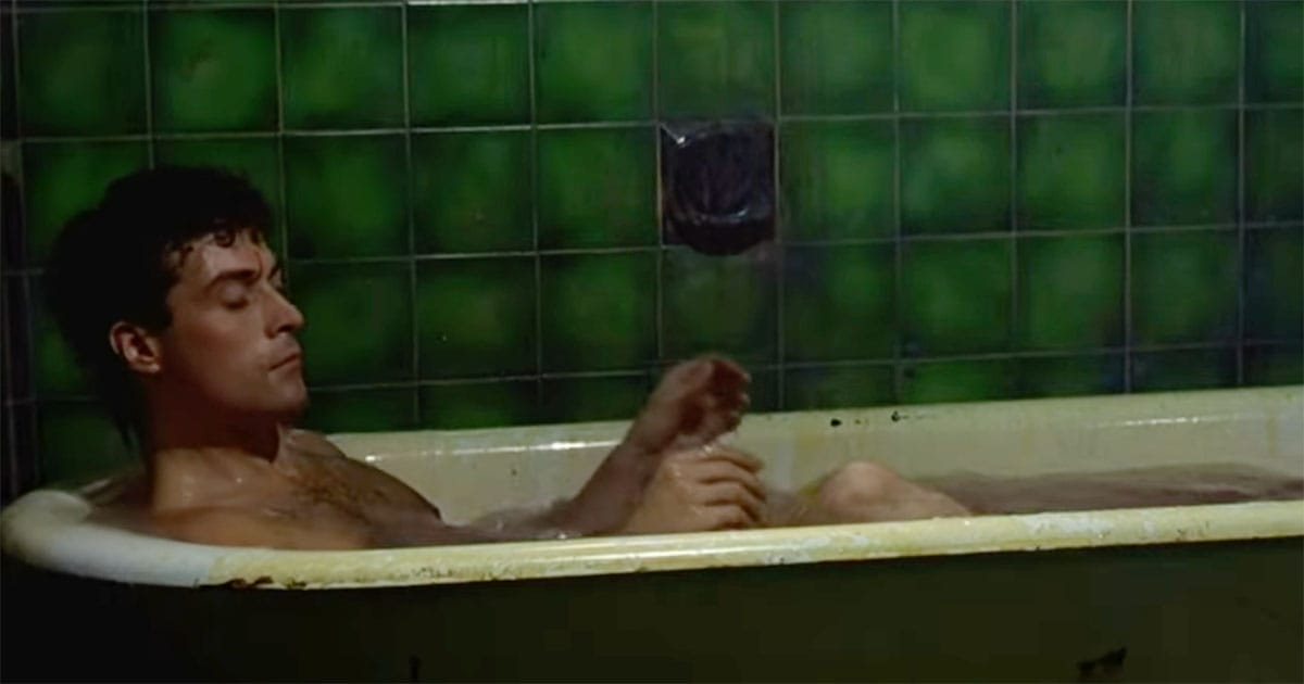 John Murdoch lies in a bathtub surrounded by green tiles, unaware of who he is or where he is, from “Dark City.”
