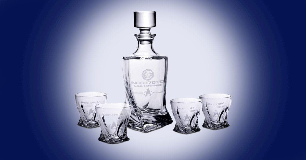 Star Trek USS Enterprise whiskey decanter set with glass decanter and four matching tumblers featuring NCC 1701 D insignia.