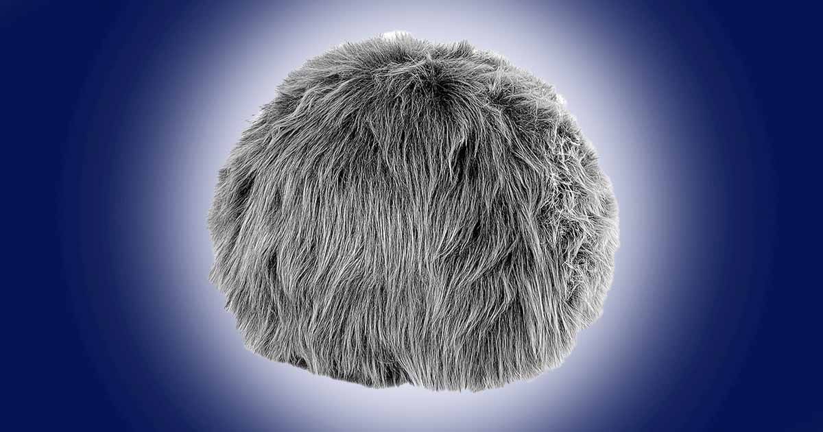 Star Trek interactive tribble plush in gray with soft fur design shown against a blue background.