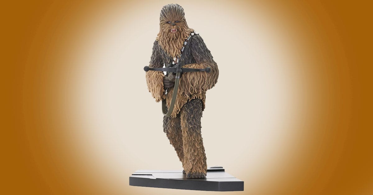 Chewbacca Star Wars statue holding bowcaster on display base from A New Hope.