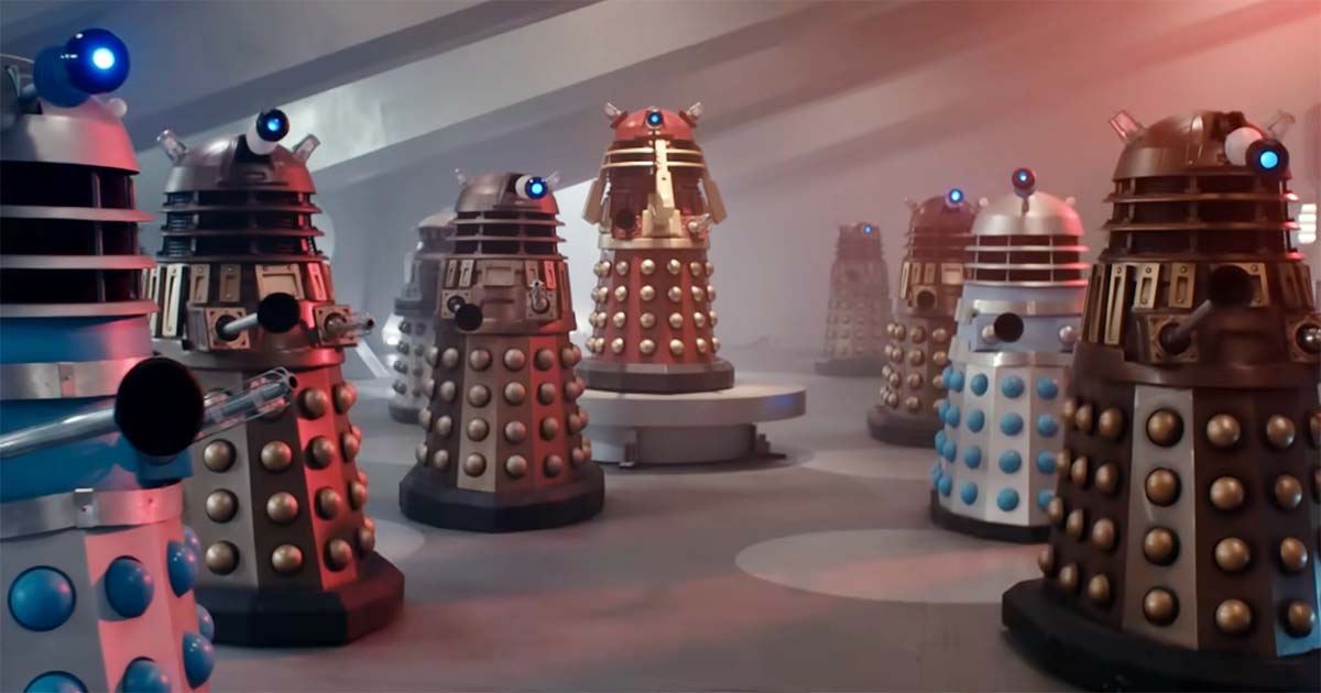 A group of Daleks assembled inside a large interior chamber in the 1965 film Doctor Who and the Daleks, arranged in an orderly formation.