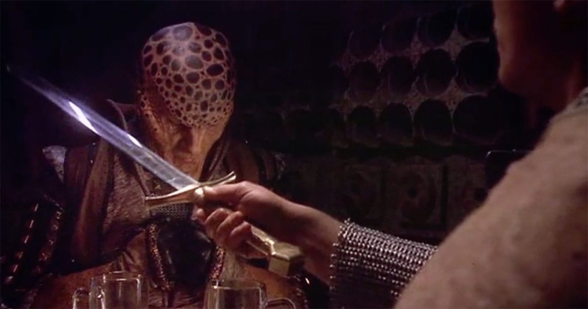 Alien character confronted with a blade during a Christmas themed episode of Babylon 5.
