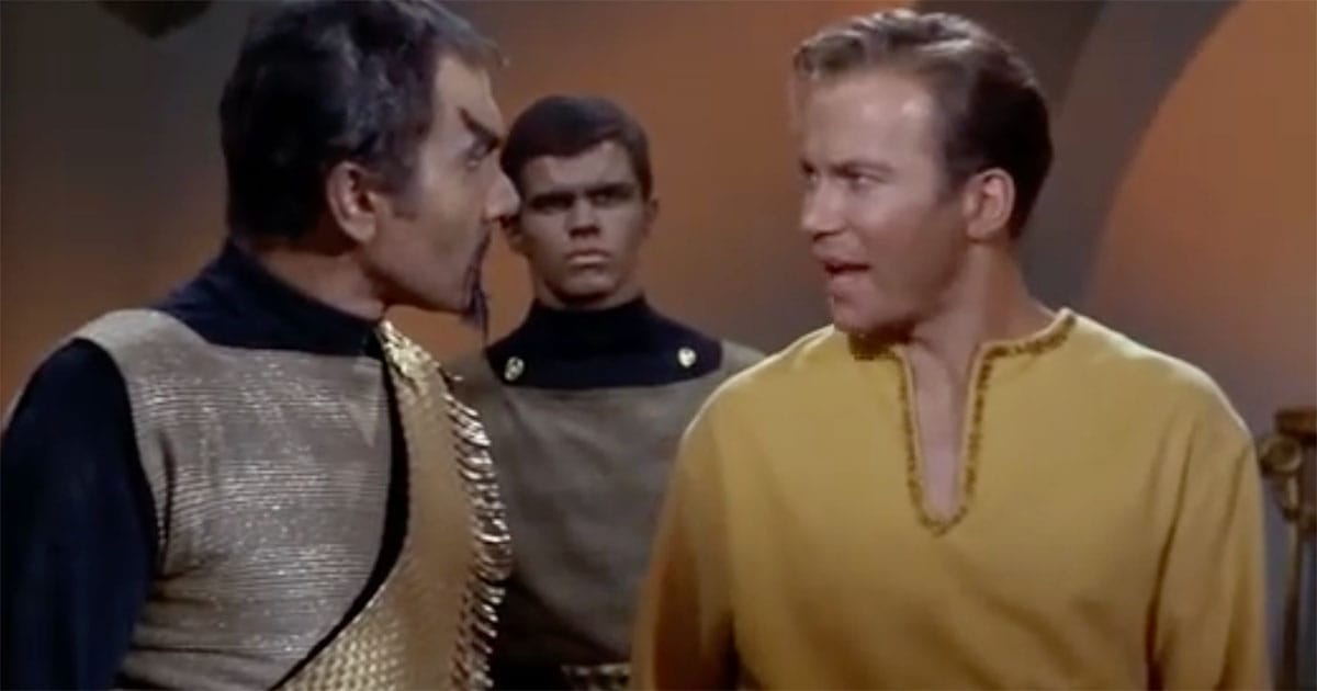 Captain Kirk faces Klingon commander Kor with a Klingon guard behind them in Star Trek Errand of Mercy.